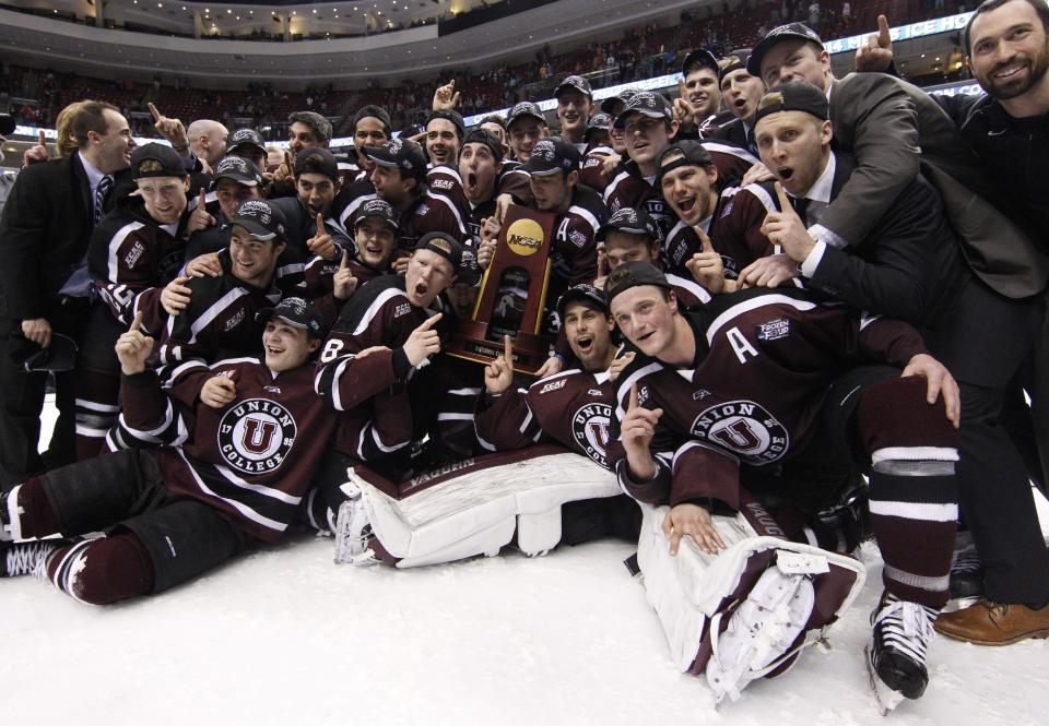 Union players pose with the trophy after winning 7-4 the Division I Championship in an NCAA men's college hockey Frozen Four tournament game against Minnesota, Saturday, April 12, 2014, in Philadelphia. (AP Photo/Chris Szagola)