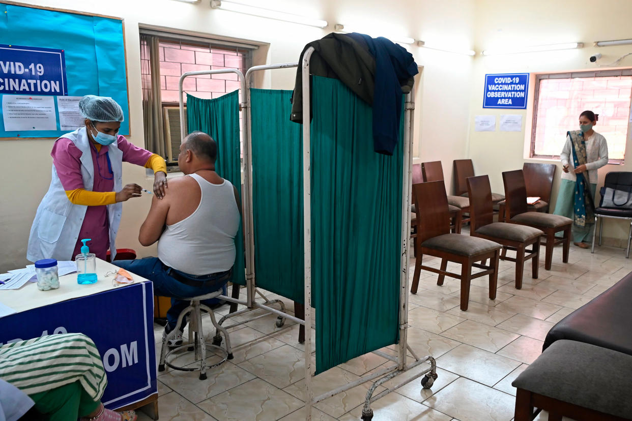 A medical worker inoculates a frontline worker with a Covid-19 vaccine at a vaccination centre in New Delhi on Feb. 13