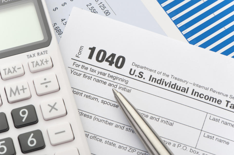 Close-up of tax return with calculator