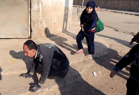 A displaced Iraqi man flees his home, as Iraqi forces battle with Islamic State militants, in western Mosul, Iraq March 8, 2017. REUTERS/Zohra Bensemra