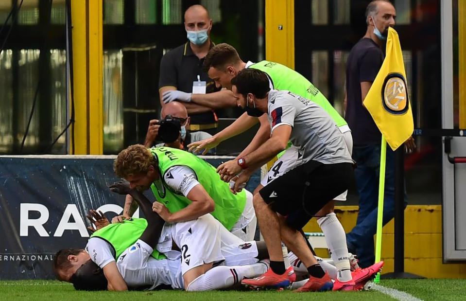 Musa Barrow is mobbed by his Bologna teammates after scoring the winner against Inter.