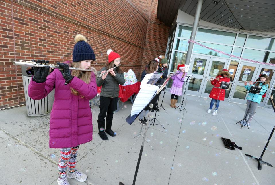 The Seventh Grade Flutists from Gates Middle School perform holiday music during the Scituate North Pole Express Movie Experience presented by the Community of Resources for Special Education Foundation at the Scituate Center for Performing Arts on Saturday, Dec. 4, 2021.