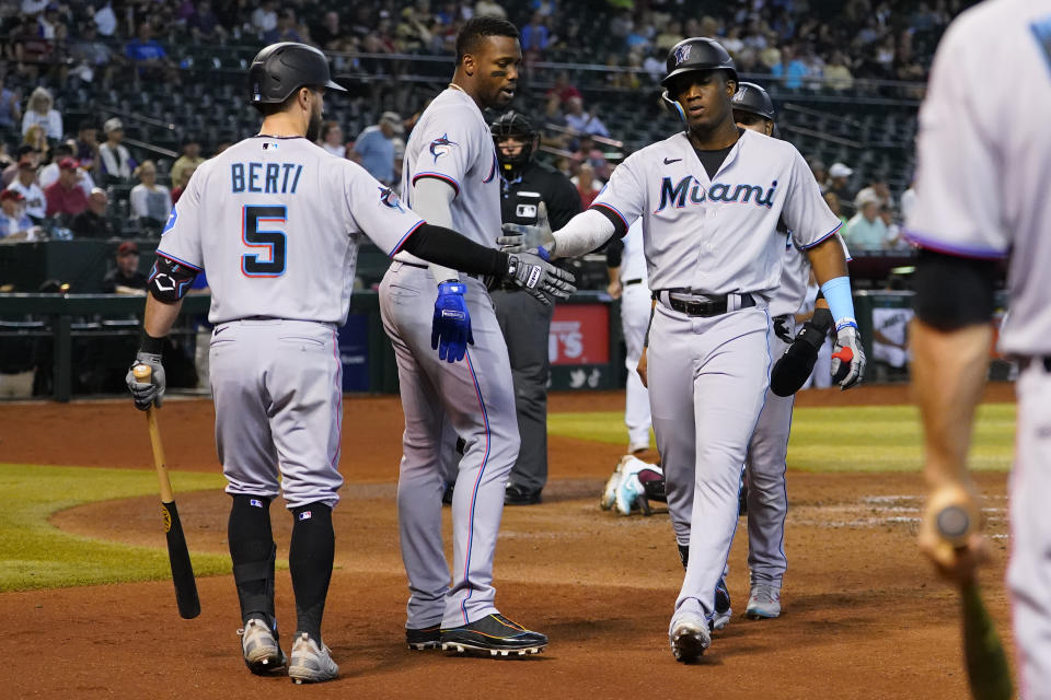 Miami Marlins' Jesus Sanchez celebrates his three run home run against the Arizona Diamondbacks with Jon Berti (5) and Jorge Soler, center, during the fourth inning of a baseball game, Wednesday, May 10, 2023, in Phoenix. (AP Photo/Matt York)