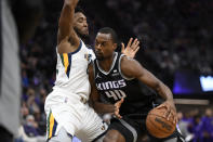 Utah Jazz guard Donovan Mitchell, tries to stop the drive of Sacramento Kings forward Harrison Barnes during the first quarter of an NBA basketball game in Sacramento, Calif., Friday, Oct. 22, 2021. (AP Photo/Jose Luis Villegas)