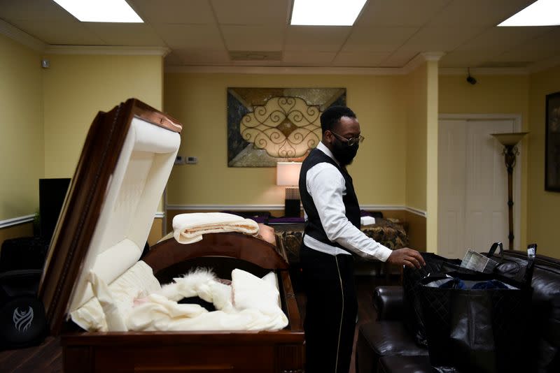 The Wider Image: 'I just ask God to help me': Texas funeral home crushed by death as U.S. COVID toll nears 500,000