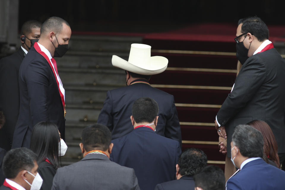 Peru's President-elect Pedro Castillo enters Congress in his signature hat to his swearing-in ceremony on his Inauguration Day in Lima, Peru, Wednesday, July 28, 2021. (AP Photo/Francisco Rodriguez)
