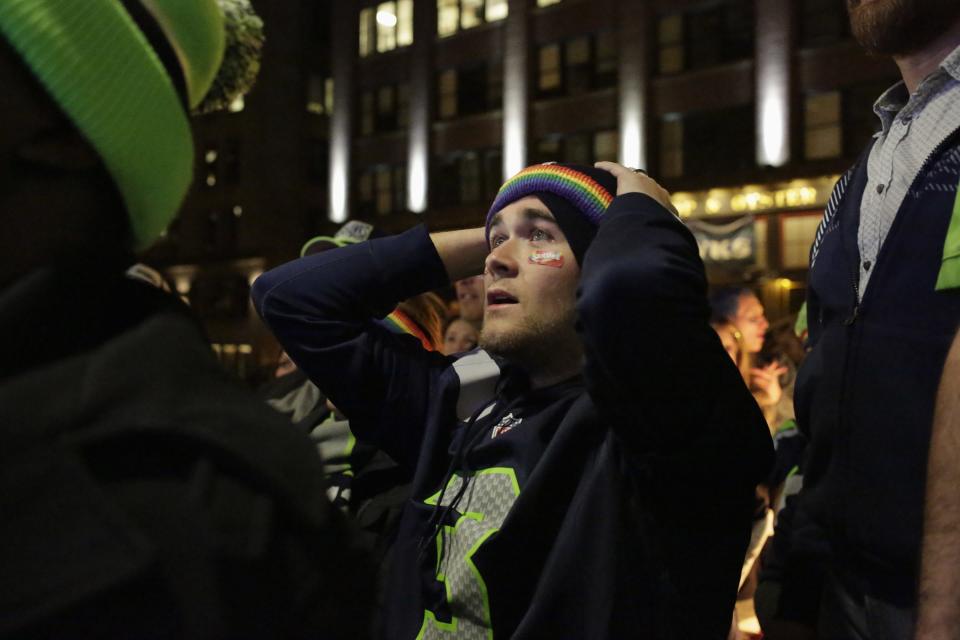 Seattle Seahawks fans react after their team lost the Super Bowl XLIX to the New England Patriots, in Seattle, Washington February 1, 2015. The New England Patriots beat the Seahawks 28-24 to win the NFL championship, Sunday in Glendale, Arizona. REUTERS/Jason Redmond (UNITED STATES - Tags: SPORT FOOTBALL)