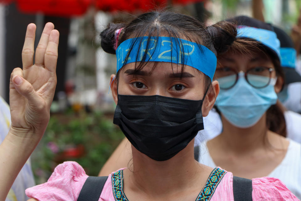 An anti-coup protester flashes the three-fingered salute while wearing a headband that reads R2P, which means Responsibility to Protect, during a gathering in Ahlone township in Yangon, Myanmar Monday, April 12, 2021. The protesters have called for foreign intervention to aid them under the doctrine of Responsibility to Protect, or R2P, devised to deal with matters such as genocide, war crimes, ethnic cleansing and crimes against humanity. (AP Photo)