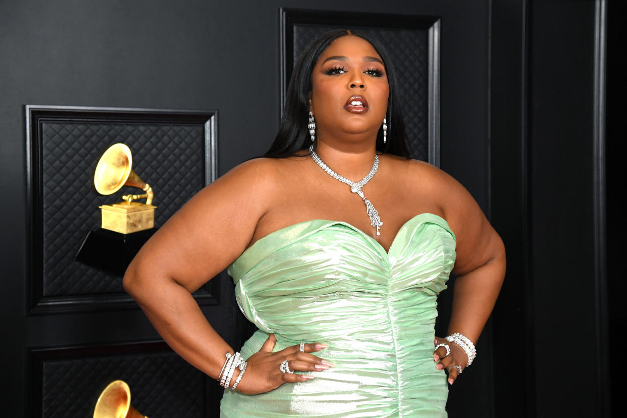 Singer Lizzo, 33, spiced up social media on Saturday with a sultry series of photos of herself sporting lime green hair and a rhinestone bra top. (Photo: Kevin Mazur/Getty Images for The Recording Academy)