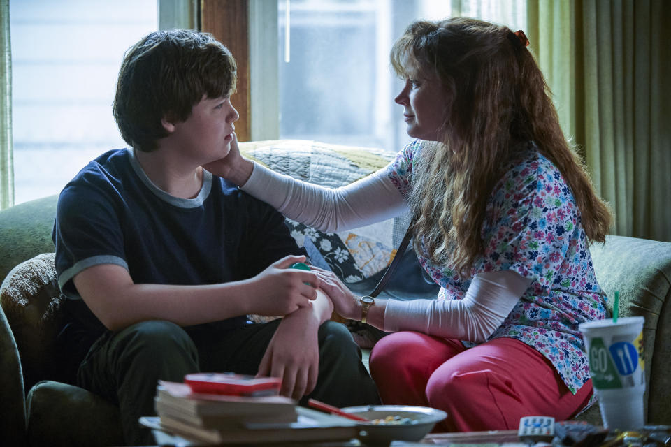 This image released by Netflix shows Owen Asztalos, left, and Amy Adams in a scene from "Hillbilly Elegy." After two weeks in select cinemas, Ron Howard's film begins streaming Tuesday on Netflix. (Lacey Terrell/Netflix via AP)