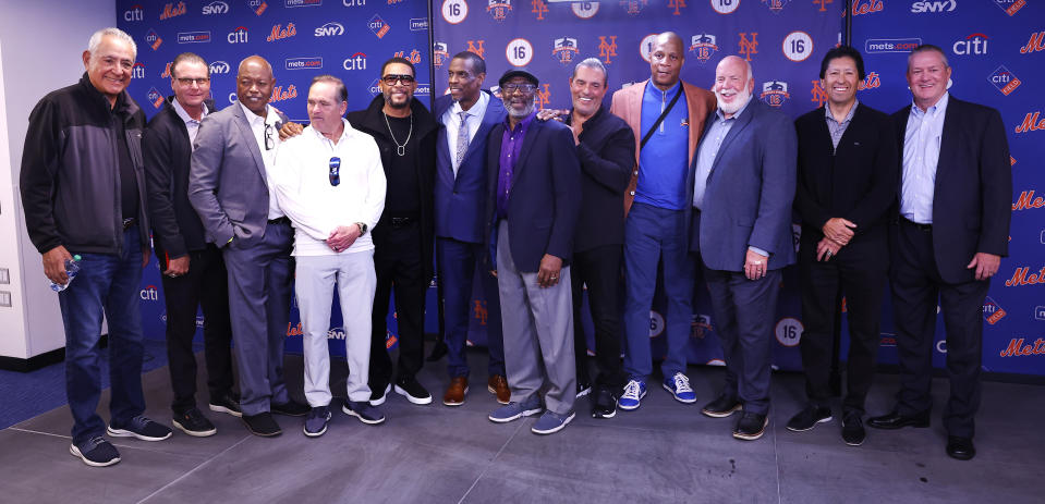 Former Mets gather with pitcher Dwight Gooden, center, during press conference before ceremony to retire his number at Citi Field on Sunday, April 14, 2024, in New York. (AP Photo/Noah K. Murray)