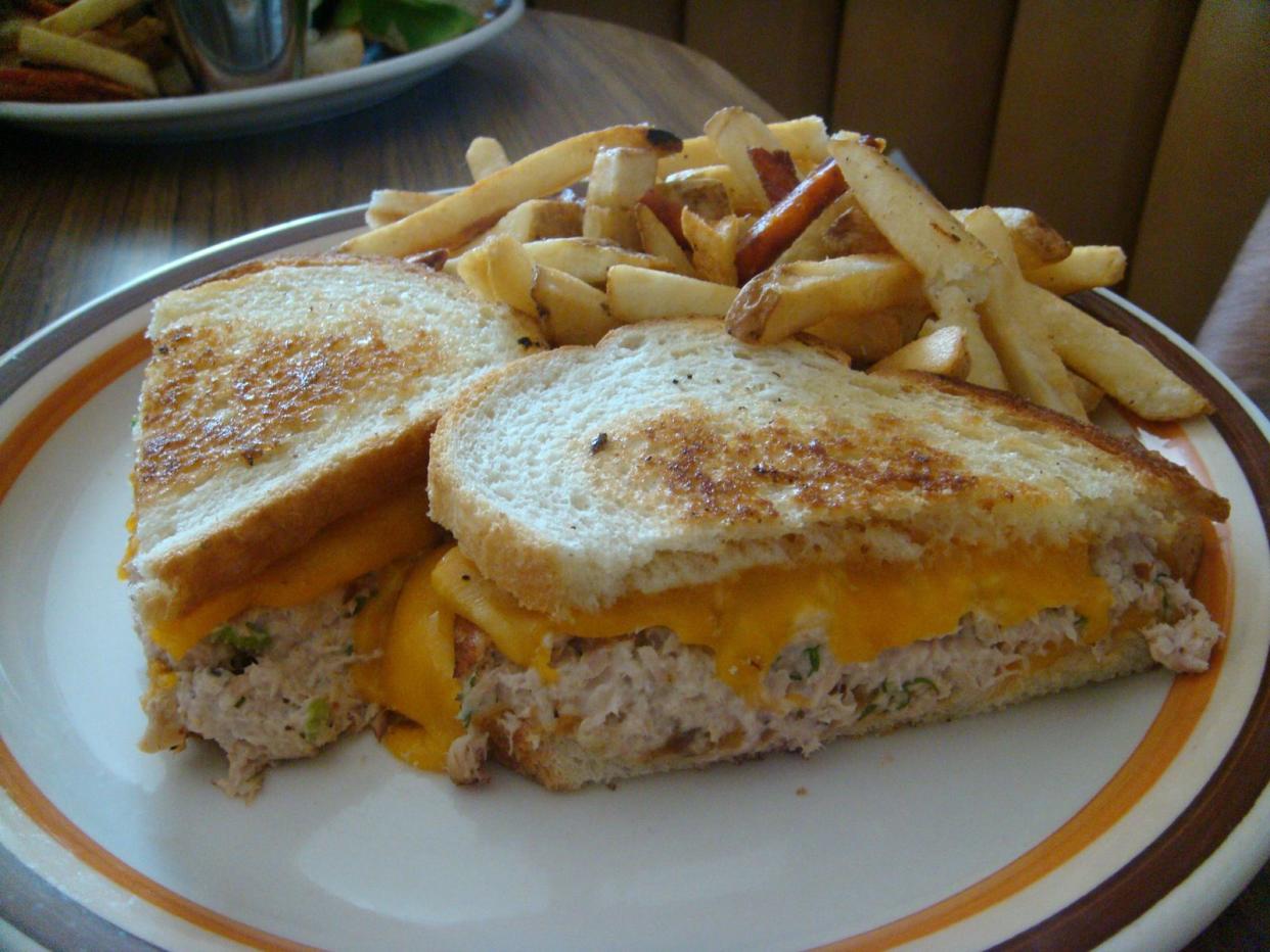 A tuna melt sandwich on a plate with French fries as served by the 101 Coffee Shop at 6145 Franklin Ave in Hollywood, California.