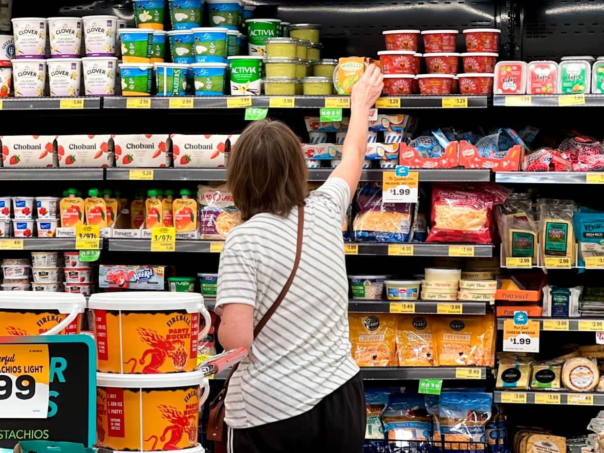 Supermarket fridges and freezers leak powerful greenhouse gases called HFCs. Switching to 'natural refrigerants' such as CO2 could make a difference in cutting emissions. (Terry Chea/AP - image credit)