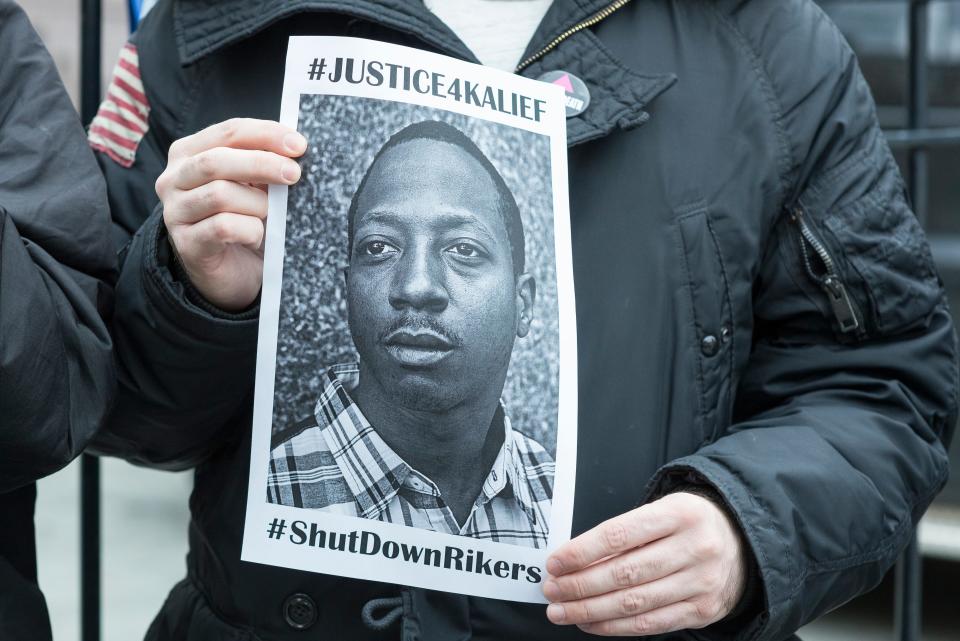 A demonstrator holds an image of Kalief Browder at a protest near New York City Hall in 2016.