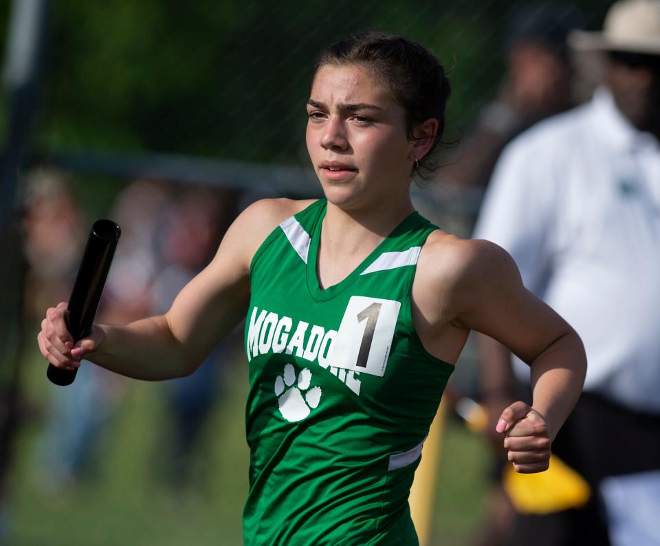 Mogadore's Katie Lane competes in the 3,200-meter relay during the Division III regional track and field meet at Perry High School on Wednesday.