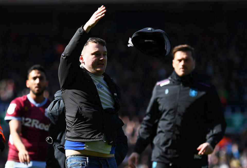 Paul Mitchell escorted off the pitch after his attack on Jack Grealish. (Credit: Getty Images)