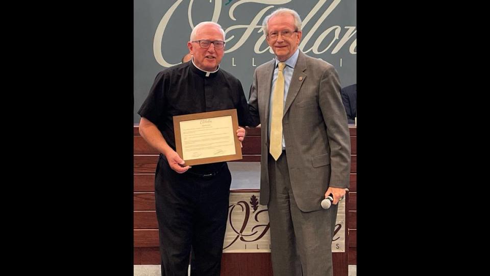 Monsignor Willliam “Father Bill” Hitpas retired from serving as the first and only pastor at St. Nicholas Church in O’Fallon for 41 years, after the Belleville Diocese established the new parish in 1982. As part of the retirement celebrations, parishioners have rededicated the Spirituality Center in his name. He is shown here with Mayor Herb Roach, after receiving a city proclamation.