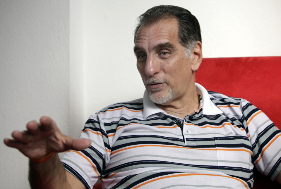 In this Feb. 17, 2014 photo, Rene Gonzalez, of the “Cuban Five," speaks during an interview in Havana, Cuba. Gonzalez was an unknown young pilot in 1990 when he pretended to steal a crop duster in Cuba and flew to Florida, using cover as a Cuban defector to spy on targets in the United States. The Cuba Five refers to intelligence agents in the employ of Fidel Castro's Cuba, they were arrested in the United States in 1998 and given terms ranging from 15 years to consecutive life sentences on charges including conspiracy and failure to register as foreign agents. (AP Photo/Franklin Reyes)