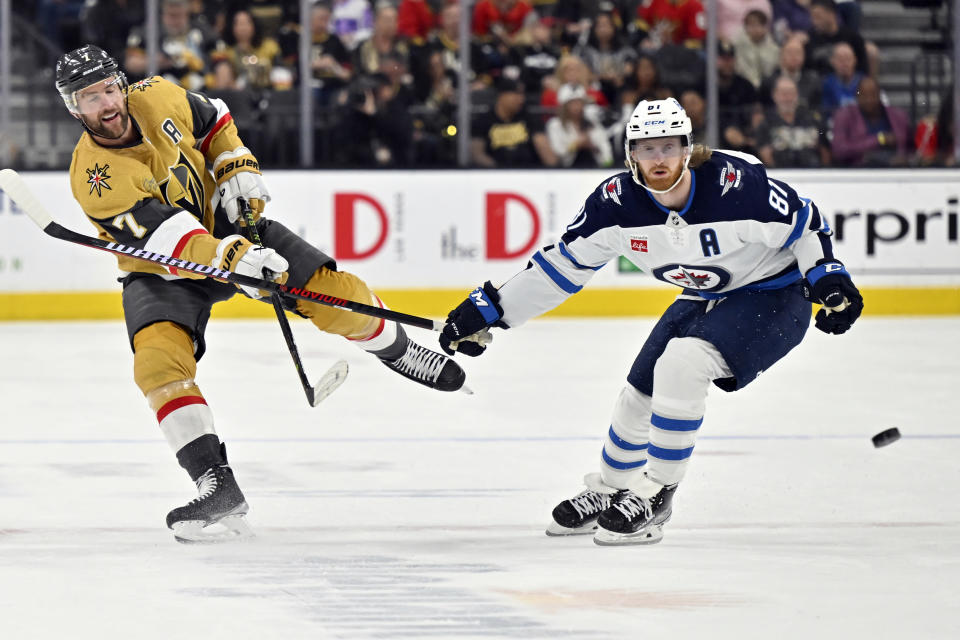 Vegas Golden Knights defenseman Alex Pietrangelo (7) shoots the puck past Winnipeg Jets left wing Kyle Connor (81) during the second period of Game 5 of an NHL hockey Stanley Cup first-round playoff series Thursday, April 27, 2023, in Las Vegas. (AP Photo/David Becker)