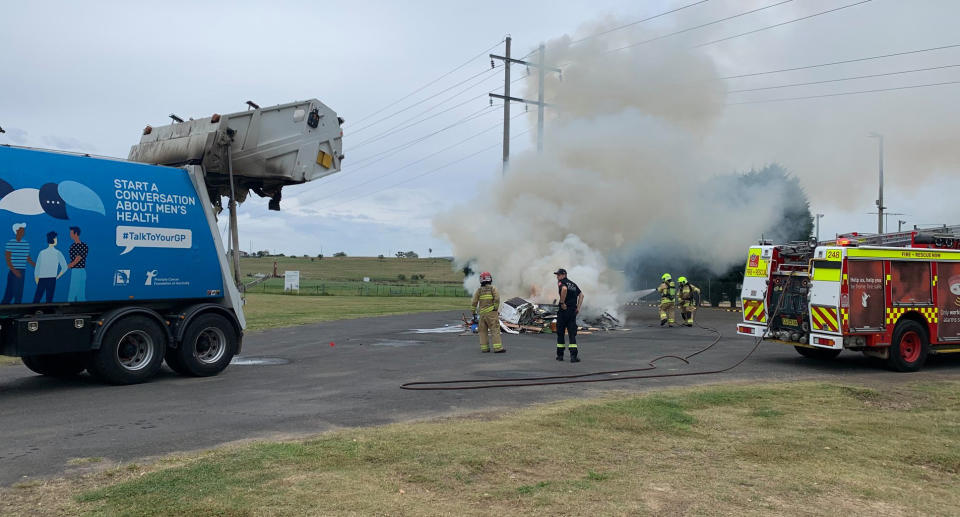 Garbage is seen on fire in Camden, NSW.