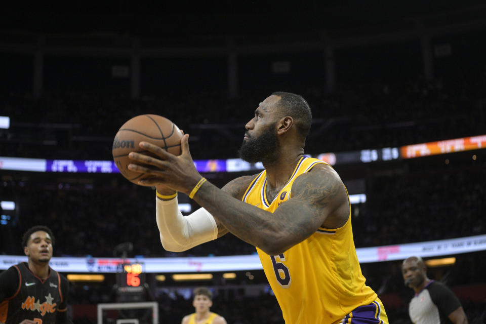 Los Angeles Lakers forward LeBron James (6) sets up for a shot during the first half of an NBA basketball game against the Orlando Magic, Friday, Jan. 21, 2022, in Orlando, Fla. (AP Photo/Phelan M. Ebenhack)