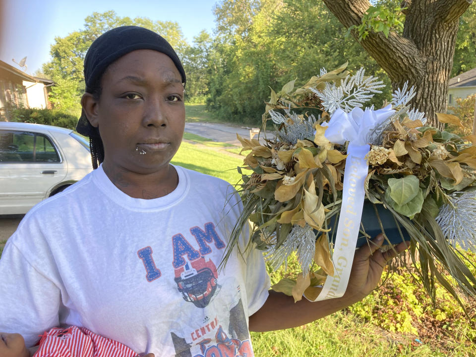 Ericka Lotts holds a bouquet from her son's funeral in this photo taken Friday, Sept. 17, 2021, at her home in Ferguson, Missouri. Martin died of a gunshot wound in rural Missouri in April. Though investigators initially called it a suicide, a coroner's inquest jury ruled that Martin died of violence.(AP Photo by Jim Salter)