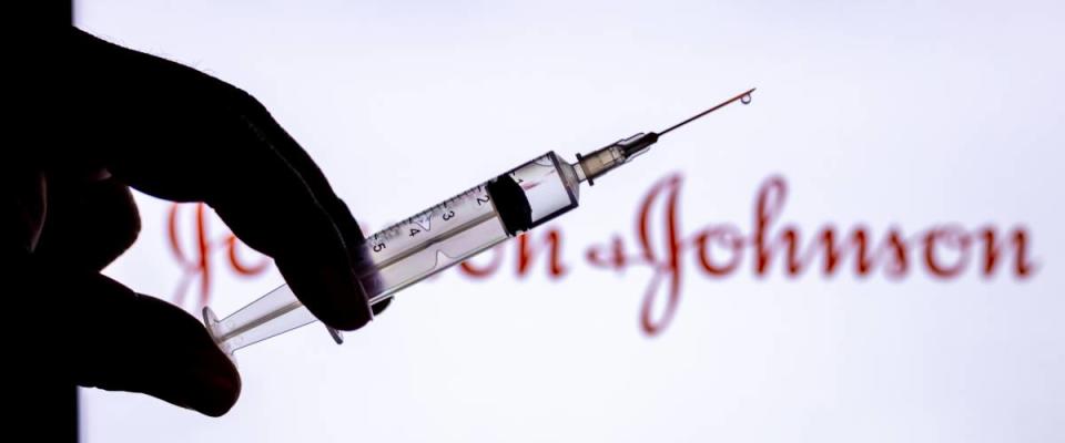 Syringe Injection placed against Johnson and Johnson logo.