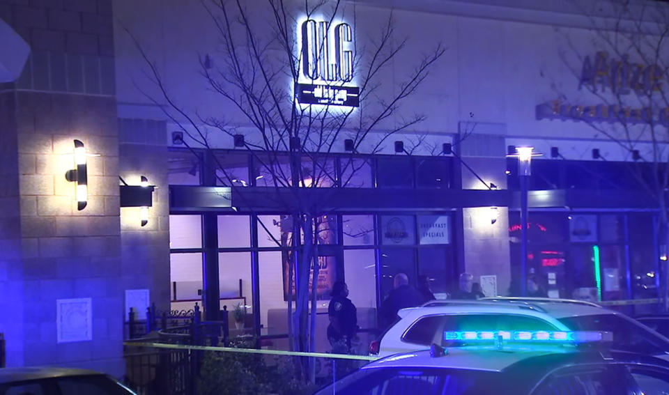 In this image from video provided by WSB-TV, police officers stand outside Old Lady Gang restaurant Friday, Feb. 14, 2020, in East Point, Ga. Three people were shot and wounded at the restaurant just outside Atlanta that's owned by singer and “Real Housewives of Atlanta” star Kandi Burruss. A man entered the Old Lady Gang restaurant and targeted another man, East Point police Capt. Allyn Glover told news outlets. Police say two bystanders were also shot, and all three shooting victims suffered non-life-threatening injuries. (WSB-TV via AP)