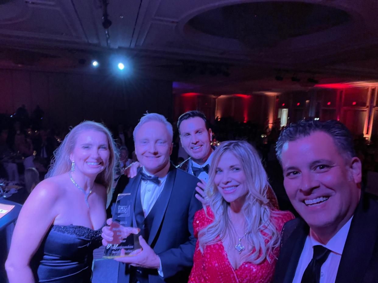 DSUSD Superintendent Scott Bailey — flanked by co-chair Kathleen Doyle, KESQ's Peter Daut, co-chair Caroline Sofonio and DESF Director Sean Webb — shows off his award for Staff Member Honoree of the Year.