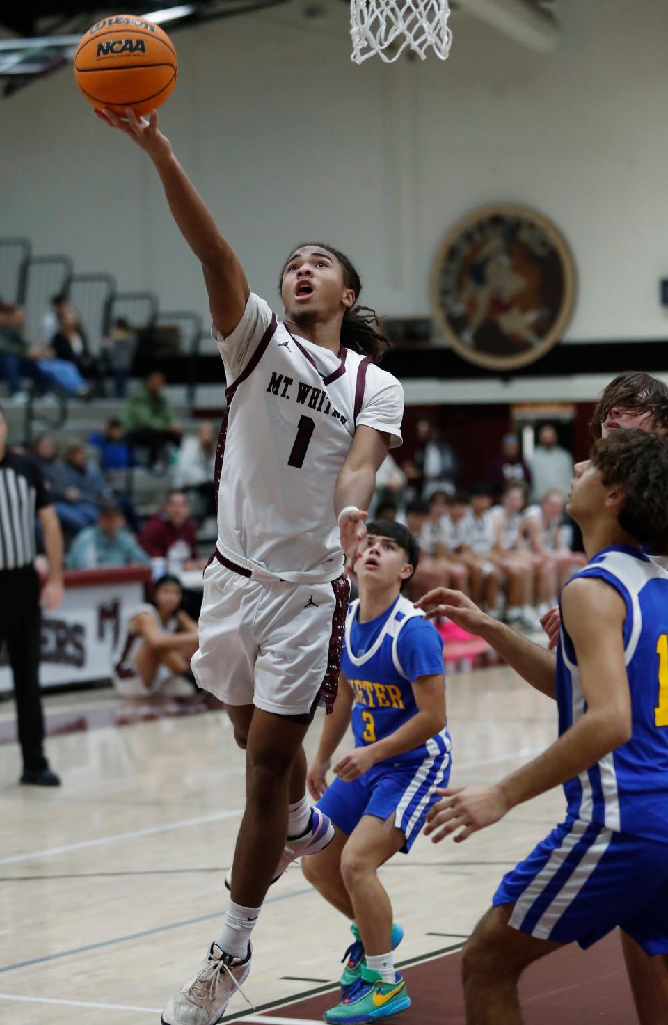 Mt. Whitney's Israel Briggs goes up strong against Exeter during their 72nd annual Polly Wilhelmsen Invitational Basketball Tournament game in Visalia, Calif., Wednesday, Dec. 27, 2023.