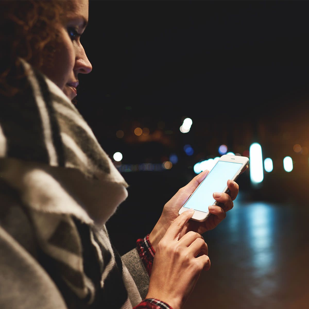 woman-using-iphone-at-night