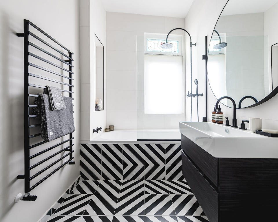 Bathroom showing a wet room with monochrome striped tiles