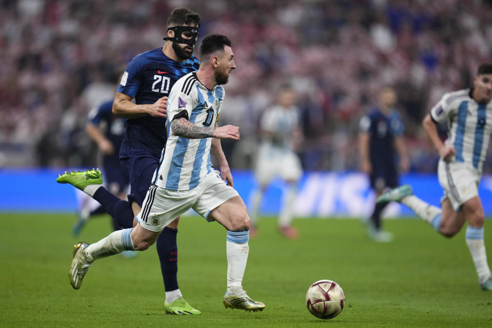 Argentina's Lionel Messi in action in front of Croatia's Josko Gvardiol during the World Cup semifinal soccer match between Argentina and Croatia at the Lusail Stadium in Lusail, Qatar, Tuesday, Dec. 13, 2022. (AP Photo/Manu Fernandez)