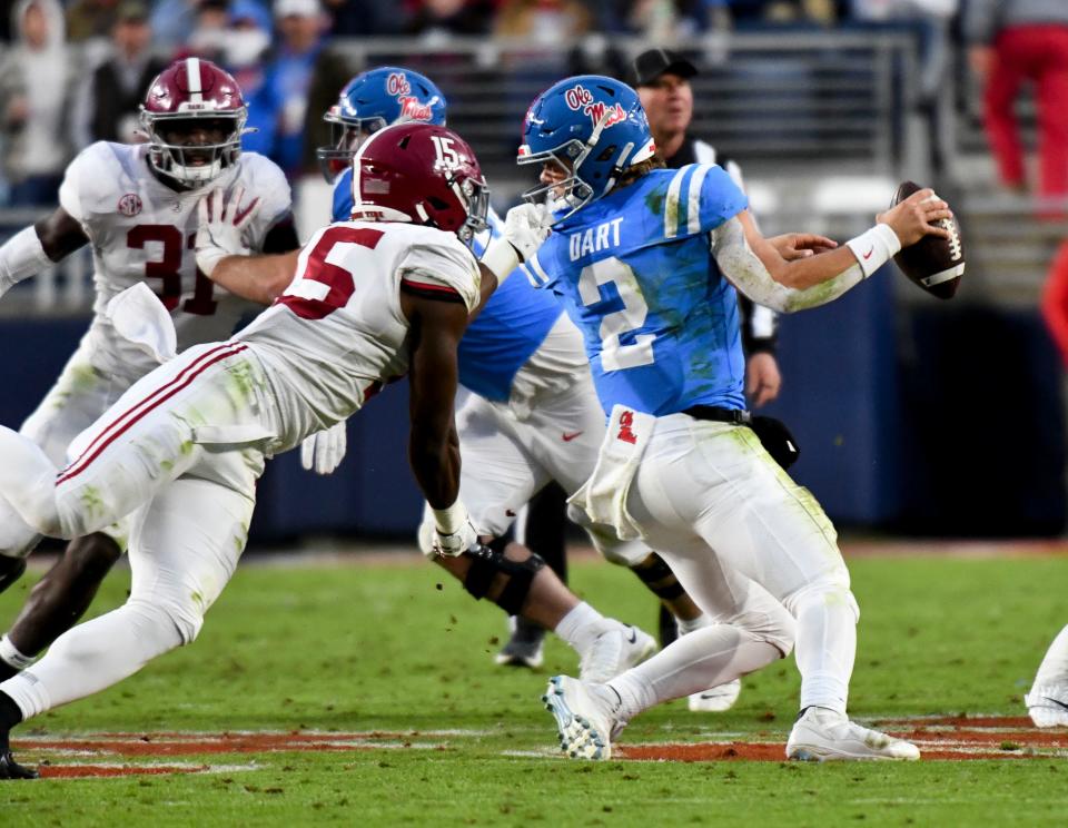 Alabama linebacker Dallas Turner pulls on the face mask of Ole Miss quarterback Jaxson Dart.