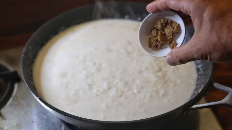 adding brown sugar to skillet