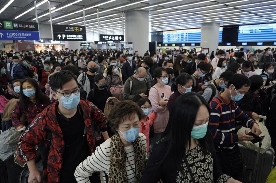 Large amounts of people in Wuhan all wearing face masks.