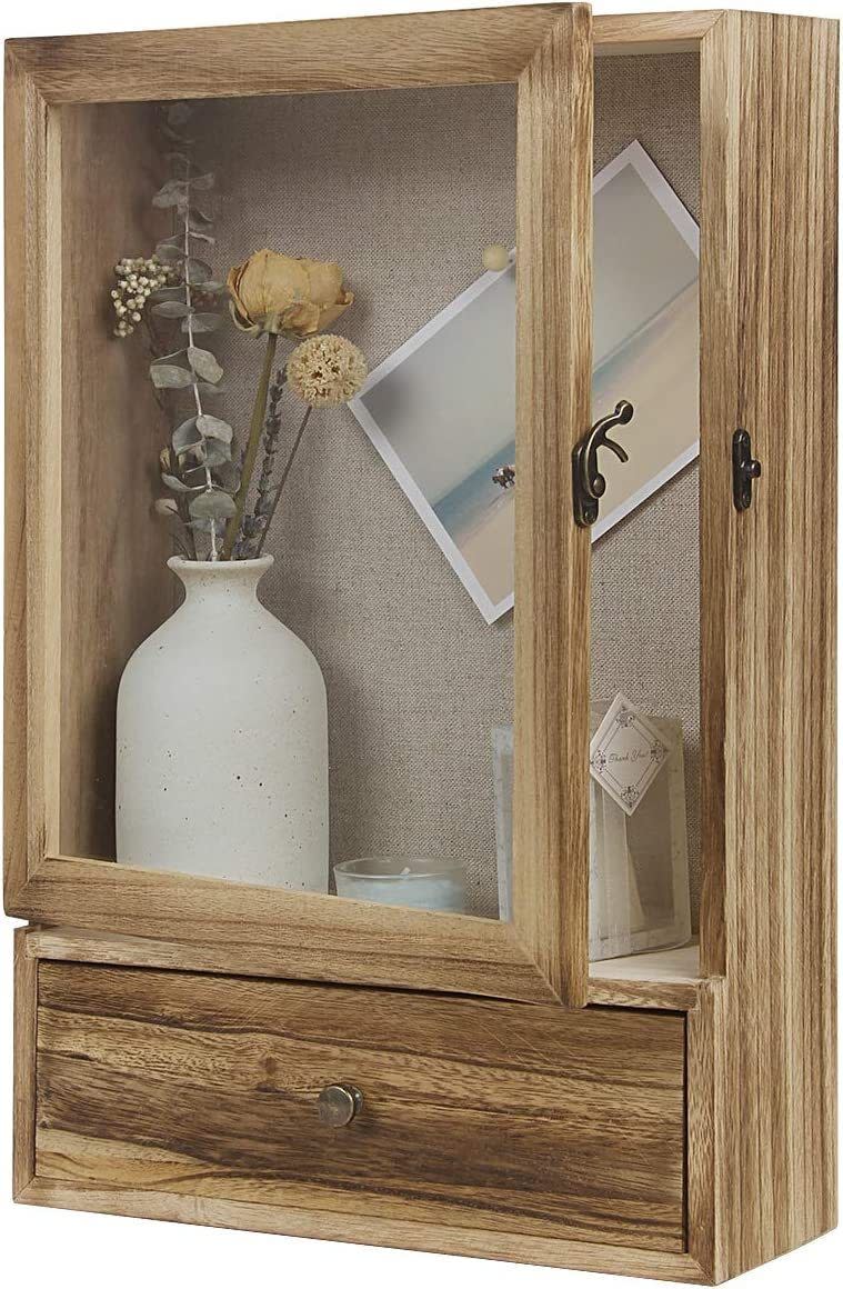 <div><p>"Personal mementos are great for boosting positivity," Kase said. "You can include framed photos of loved ones, souvenirs from trips, family heirlooms or other meaningful items. It can be anything that makes you smile."This real wood shadow box measures 11 inches by 16.5 inches and has an inner linen-lined pad you can use push pins on. </p><p><i>You can buy the <a href="https://www.amazon.com/dp/B08SLPBPWJ" rel="nofollow noopener" target="_blank" data-ylk="slk:shadow box display case;elm:context_link;itc:0;sec:content-canvas" class="link ">shadow box display case</a> from Amazon for around $35. </i></p></div><span> Amazon</span>