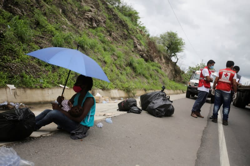 A migrant rests with her baby as migrants, which are stranded in Honduras after borders were closed due to the coronavirus disease (COVID-19) outbreak, rest while trekking northward in an attempt to reach the United States, in Choluteca