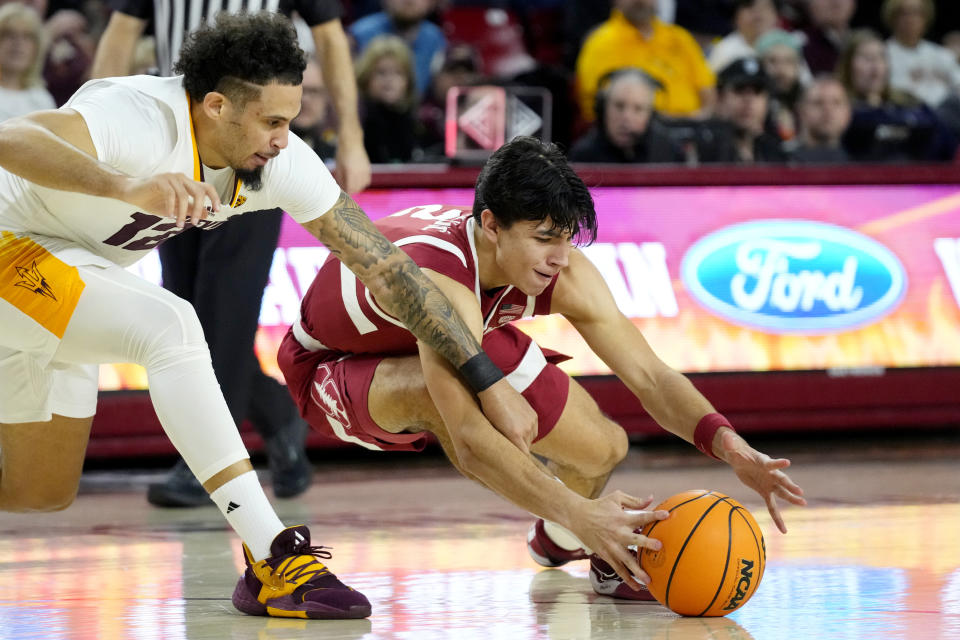 Arizona State guard Jose Perez, left, battles with Stanford Cardinal guard Andrej Stojakovic, right, for a loose ball during the first half of an NCAA college basketball game Thursday, Feb. 1, 2024, in Tempe, Ariz. (AP Photo/Ross D. Franklin)