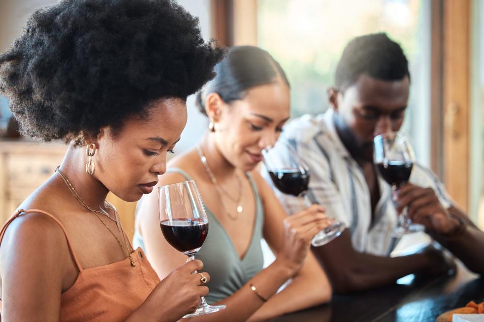 friends red wine tasting fine dining experience at a vineyard restaurant for about us and hospitality group of black people glass of luxury, quality alcohol drink in a winery business or industry