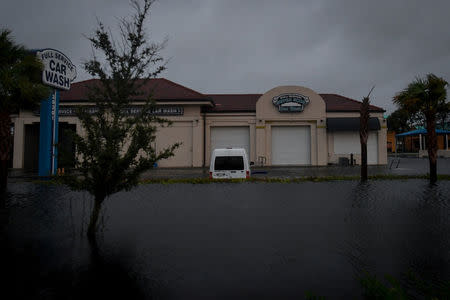 Floodwater from Hurricane Irma surrounds a car wash in Bonita Springs, Florida, U.S., September 10, 2017. REUTERS/Bryan Woolston