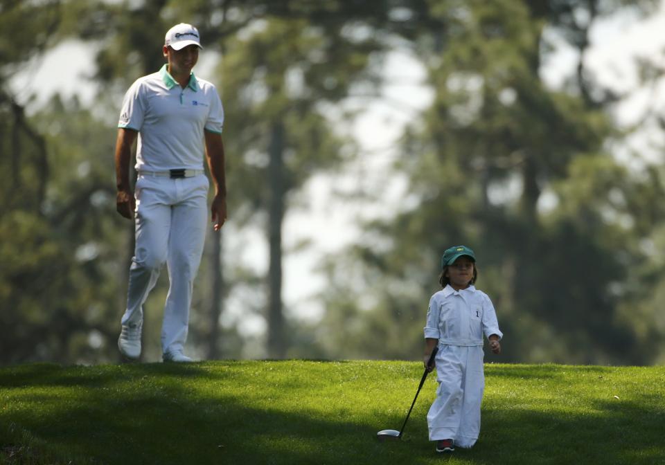 Jason Day of Australia and his son Dash attend the par 3 event ahead of the 2015 Masters at Augusta National Golf Course in Augusta, Georgia April 8, 2015. REUTERS/Mark Blinch