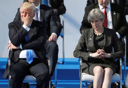 U.S. President Donald Trump (L) and Britain's Prime Minister Theresa May react during a ceremony at the new NATO headquarters before the start of a summit in Brussels, Belgium, May 25, 2017. REUTERS/Christian Hartmann