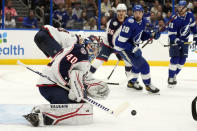 Columbus Blue Jackets goaltender Daniil Tarasov (40) makes a save as Tampa Bay Lightning left wing Nicholas Paul (20) looks for the rebound during the second period of an NHL hockey game Thursday, Dec. 15, 2022, in Tampa, Fla. (AP Photo/Chris O'Meara)