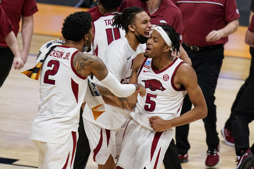 Arkansas forward Vance Jackson (2) and Arkansas guard Moses Moody (5) celebrate after a 68-66 win over Texas Tech in a second-round game in the NCAA men's college basketball tournament at Hinkle Fieldhouse in Indianapolis, Sunday, March 21, 2021. (AP Photo/Michael Conroy)