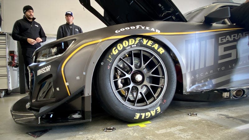 The front left corner of a black Chevrolet Camaro stock car