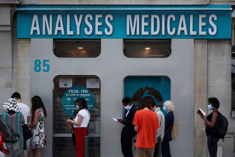 People queue to enter a laboratory to get tested for the coronavirus disease (COVID-19) in Neuilly-sur-Seine, near Paris