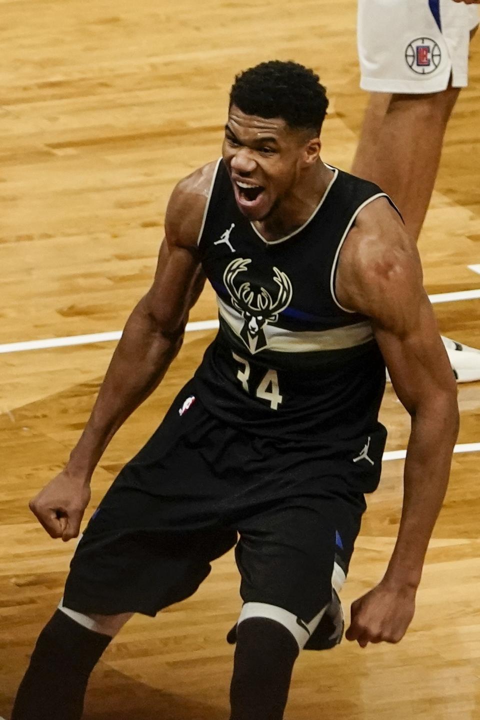 Milwaukee Bucks' Giannis Antetokounmpo reacts after dunking during the second half of an NBA basketball game against the LA Clippers Sunday, Feb. 28, 2021, in Milwaukee. The Bucks won 105-100. (AP Photo/Morry Gash)