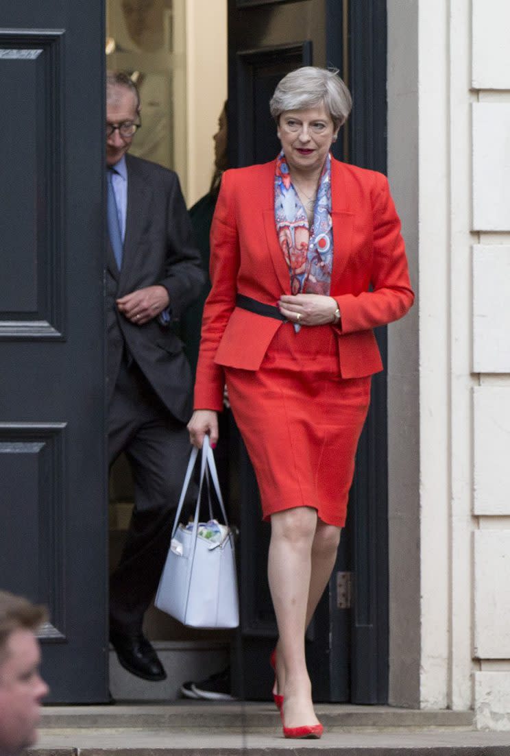 <i>May appeared on election night in matching red shoes and lips [Photo: PA]</i>