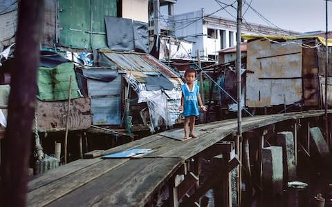 Eduardo Bantillo, 4, lives in in a house on stilts in the Tanza Dos district. According to his carer, the little boy – who is stunted – has not grown at all since the age of three. - Credit: Simon Townsley